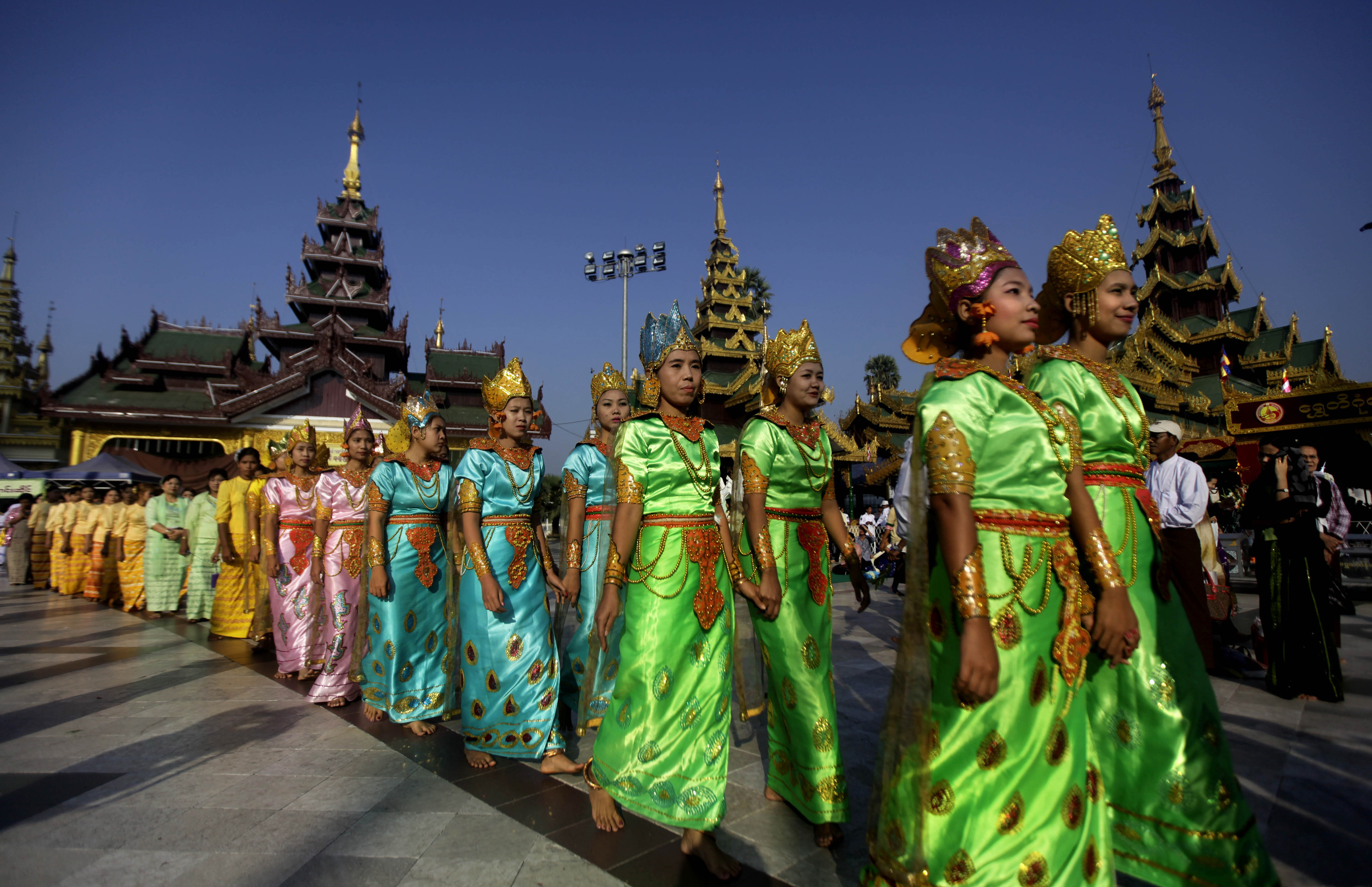 Myanmar's women in ancient dresses take part in the 2,600th anniversary celebrations of Shwedagon Pagoda in Yangon, Myanmar, Wednesday, Feb. 22, 2012. Gongs chimed as thousands of people in ceremonial costumes walked barefoot Wednesday through the marble walkways of Myanmar's most sacred Buddhist shrine in an annual festival that was banned for more than 20 years under the former military government. (AP Photo/Altaf Qadri)